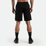 a back view for fit man wearing short with socks and shoes black 