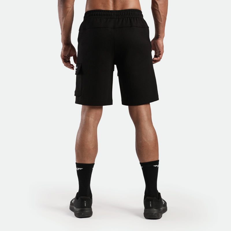 a back view for fit man wearing short with socks and shoes black 
