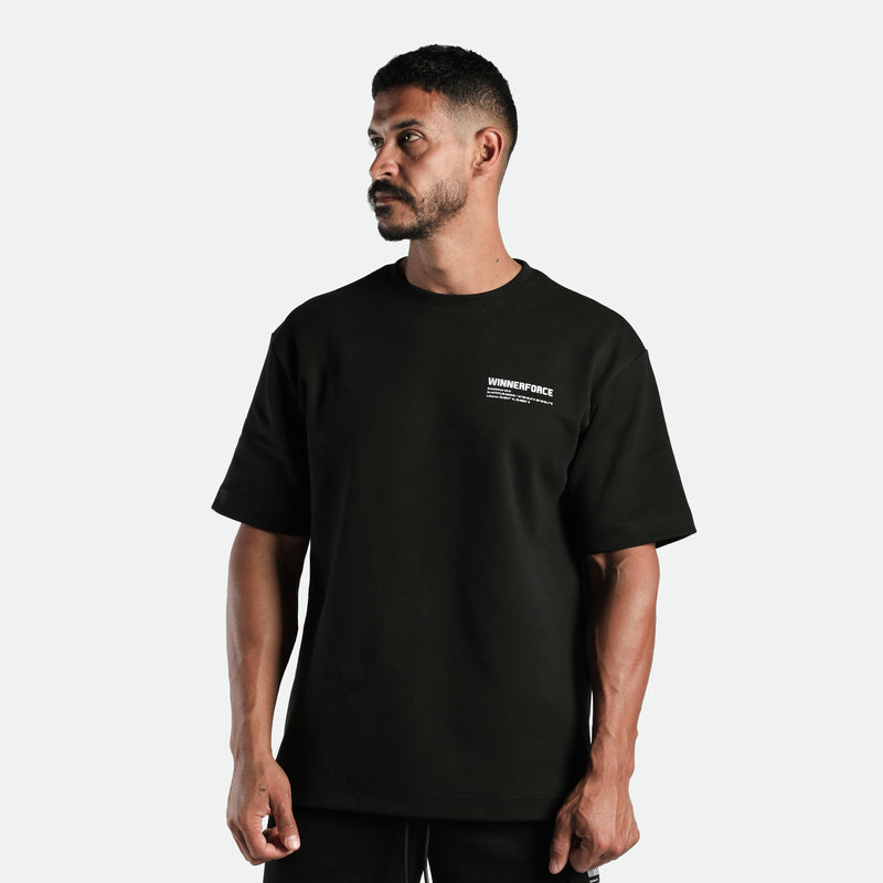a fit man stand at right and wearing  matching set black  t-shirt black with logo and short black 
