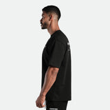 a fit man stand at right and wearing  matching set black t-shirt and short 