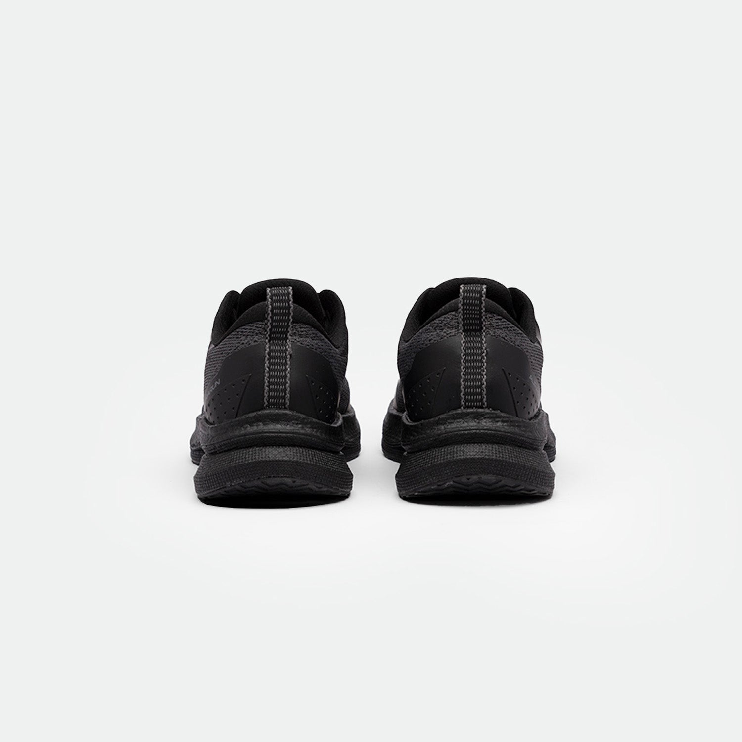 A pair of black running shoes shown from the back against a plain white background. The shoes have a sleek design, dark laces, and a textured sole.