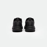 A pair of black running shoes shown from the back against a plain white background. The shoes have a sleek design, dark laces, and a textured sole.