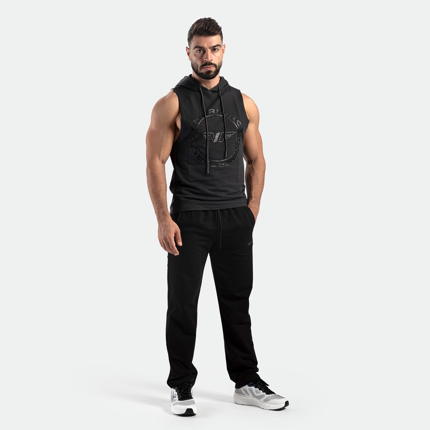 a fit man wearing half hoodie shadow black with shoes 