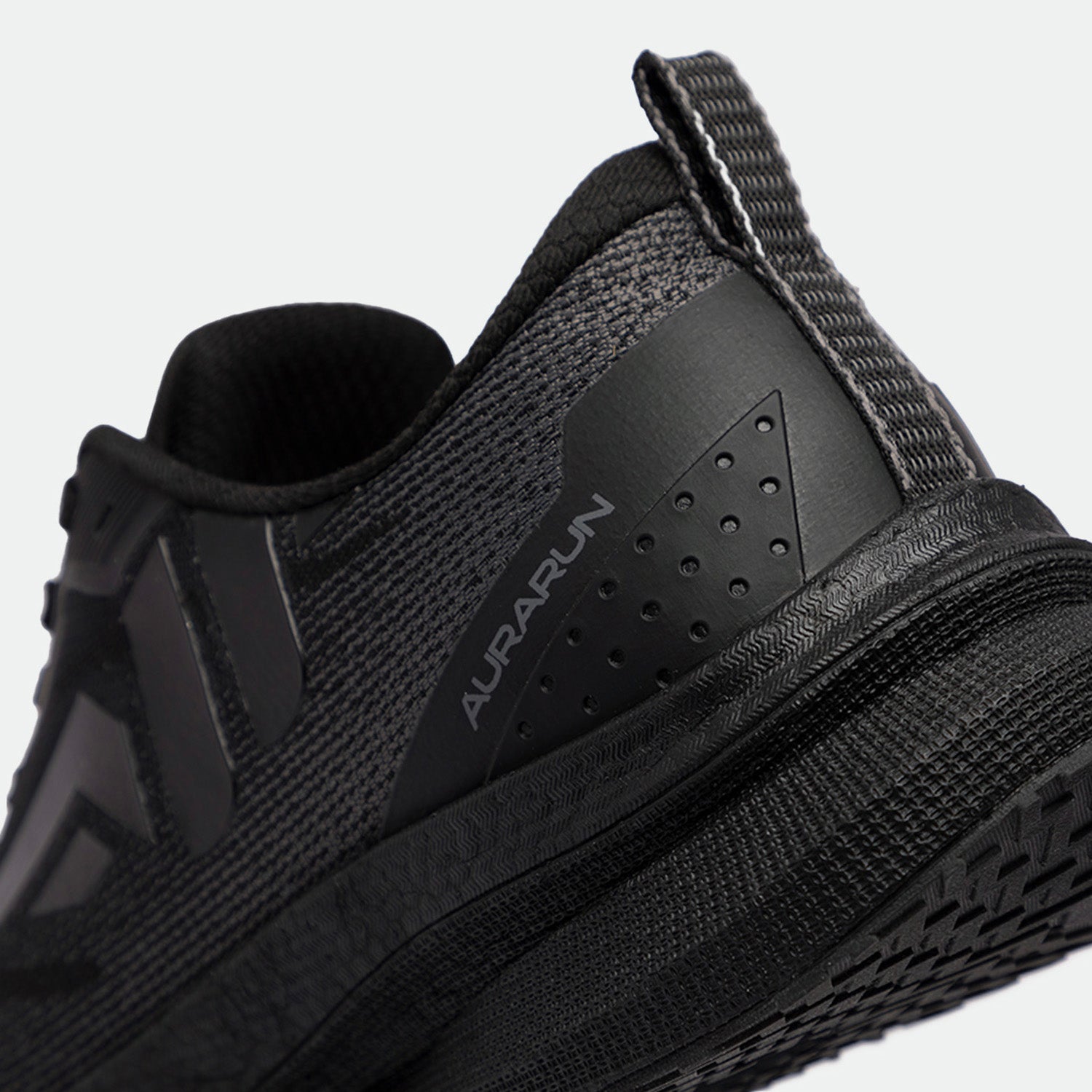 Close-up of a black athletic shoe with a sleek, textured design. The word "Aurarun" is visible on the side, conveying a modern, sporty style.
