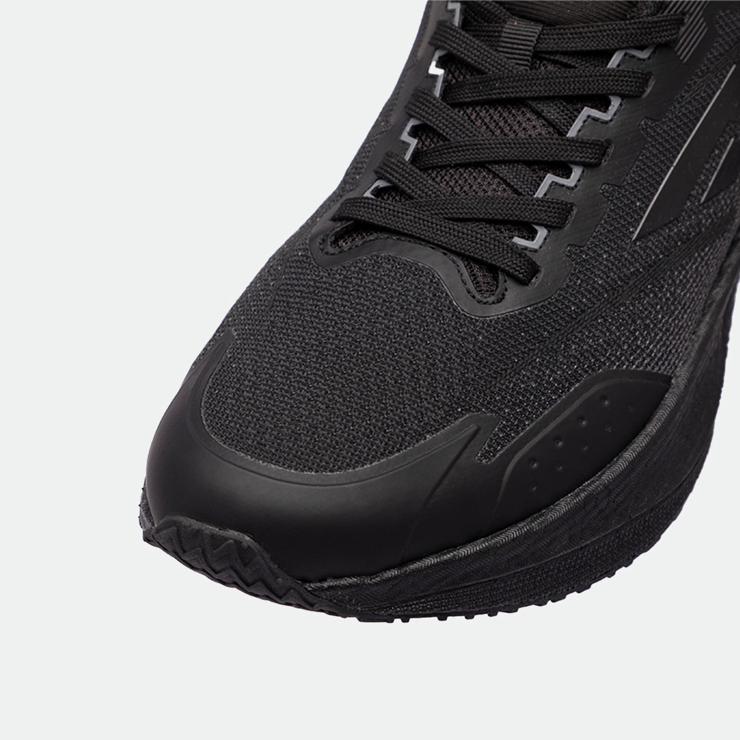 Close-up of a black athletic shoes, showcasing the textured fabric, sleek design, and intricate lacing. The shoes exudes a modern, sporty feel.