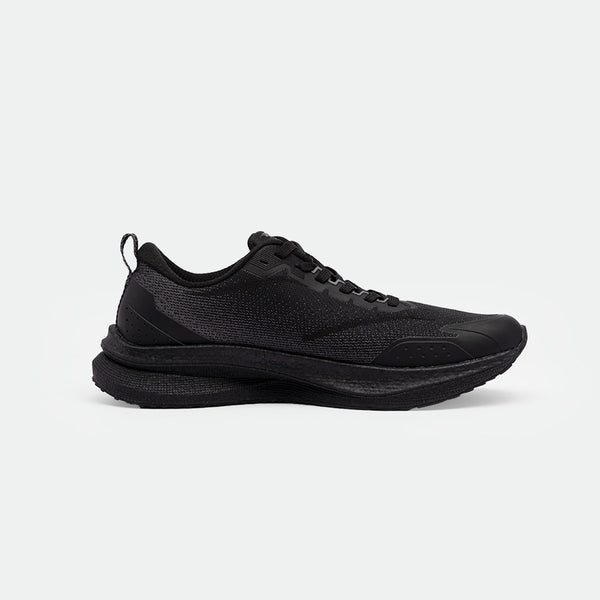 Sleek black athletic shoes with a textured mesh upper, flat black laces, and a subtle perforated pattern on the side. Displayed on a plain white background.