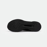 The image shows the black sole of a shoes with a textured herringbone pattern, emphasizing grip. The background is white, highlighting the details clearly.