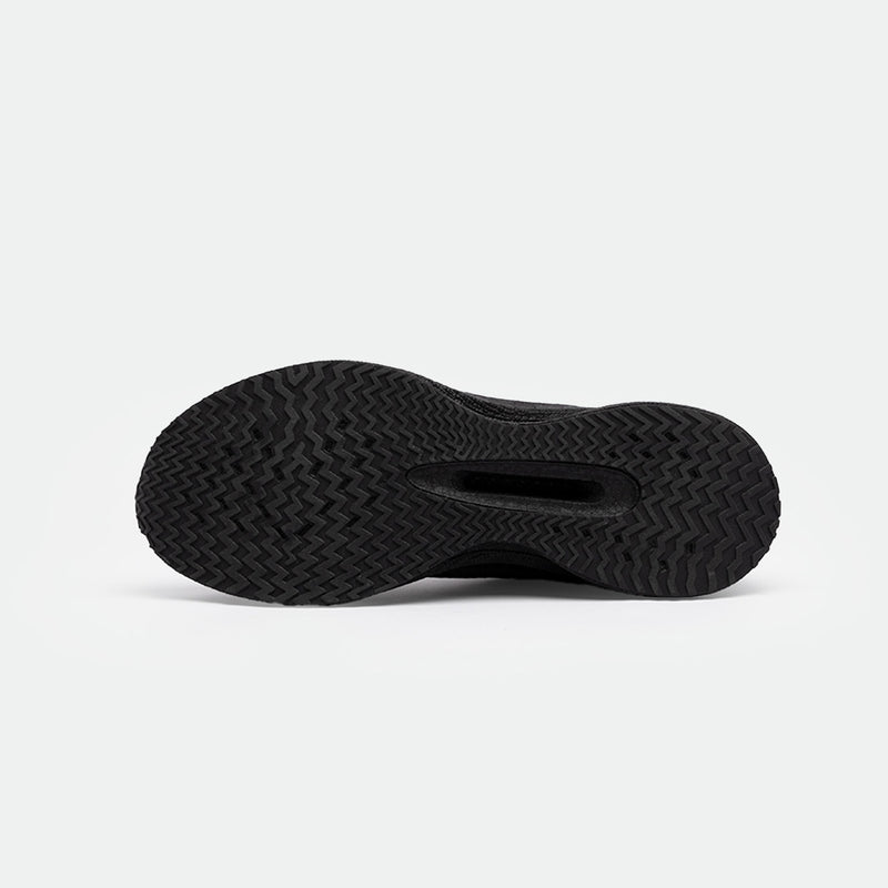 The image shows the black sole of a shoes with a textured herringbone pattern, emphasizing grip. The background is white, highlighting the details clearly.