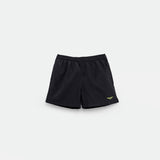 High-waisted shorts with a green logo on the front, plus a light grey background.