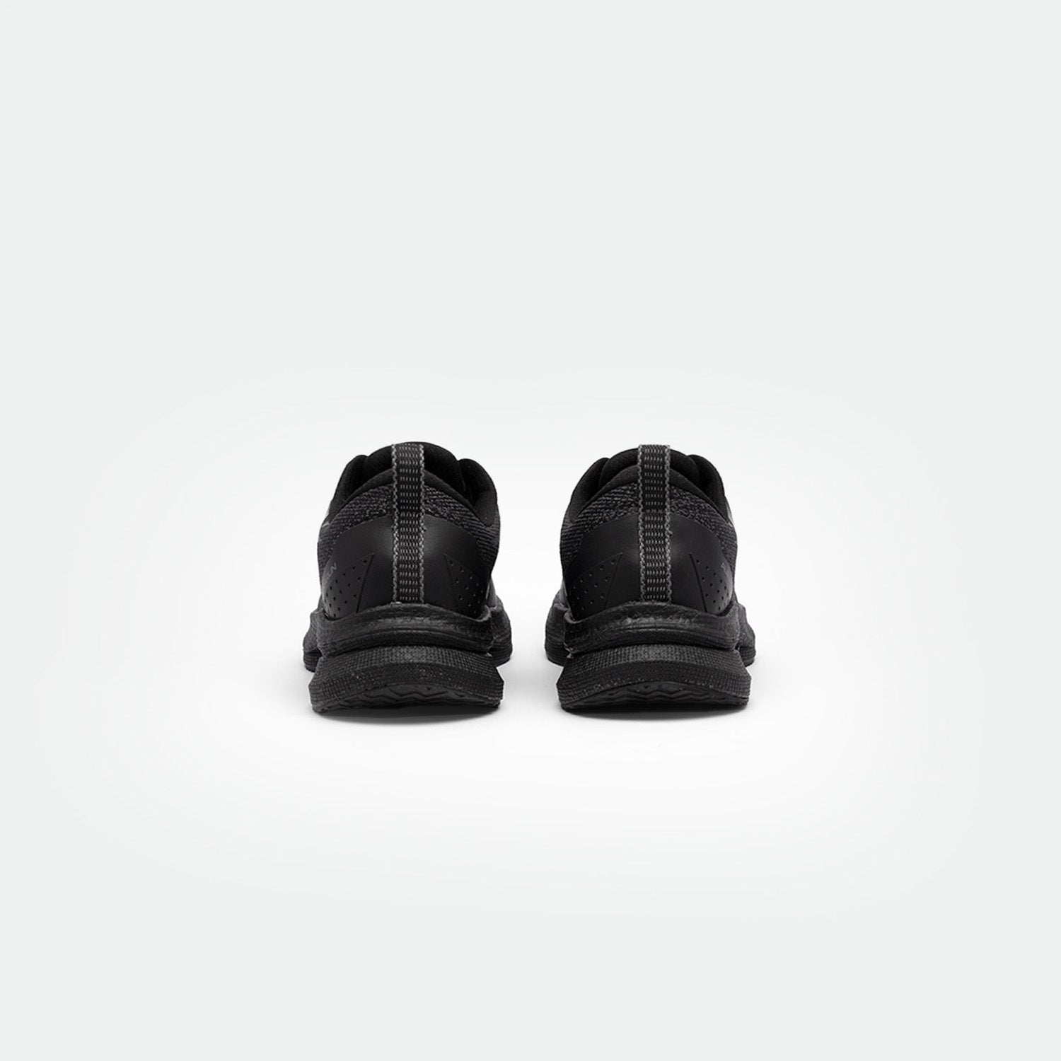 Back view of a pair of black running shoes on a white background. The shoes have textured soles, perforated details, and a sleek, modern design.