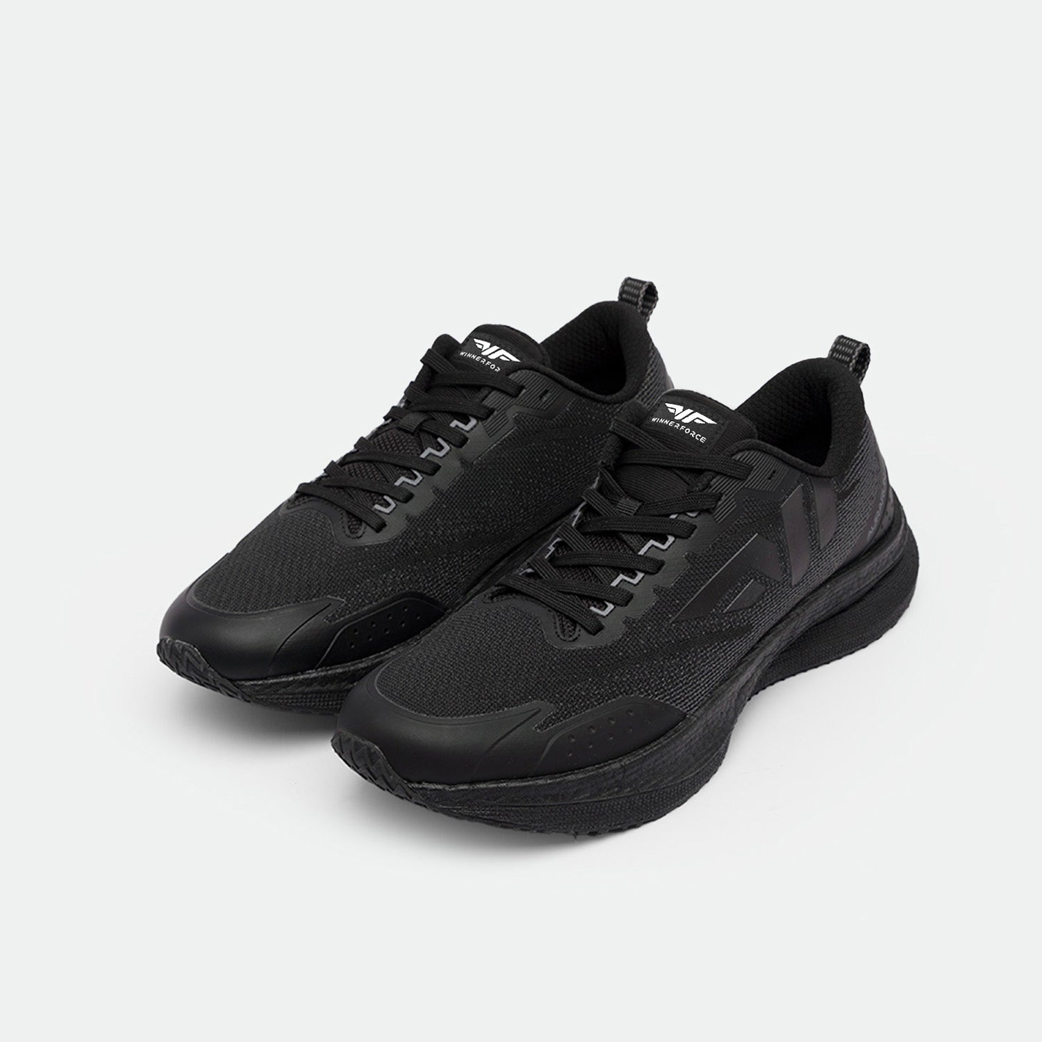 A pair of sleek black athletic sneakers with a mesh design and textured soles, positioned on a light gray background. The style exudes modern sportswear.