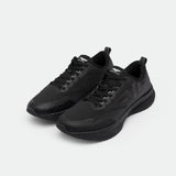 A pair of sleek black athletic sneakers with a mesh design and textured soles, positioned on a light gray background. The style exudes modern sportswear.