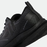 Close-up of a sleek, black athletic shoe from the heel angle, showcasing a textured, breathable mesh design and subtle branding text "AurA Run."