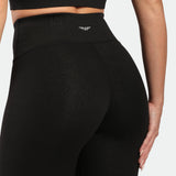 close up view for fit woman wearing legging black with logo white in half