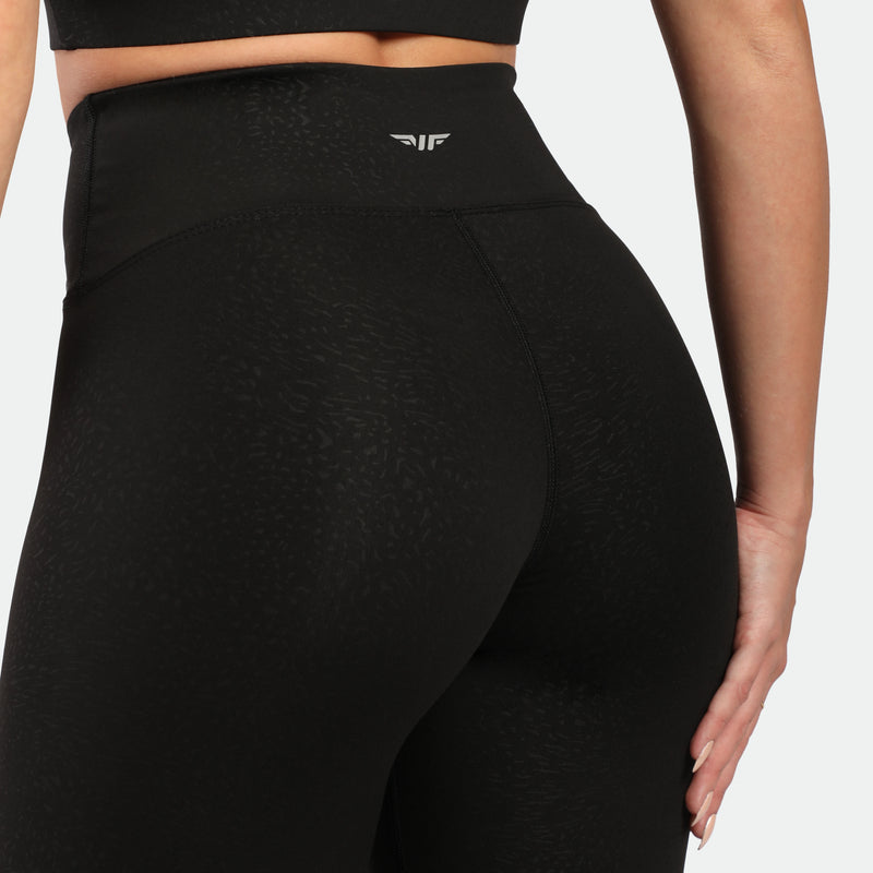 close up view for fit woman wearing legging black with logo white in half