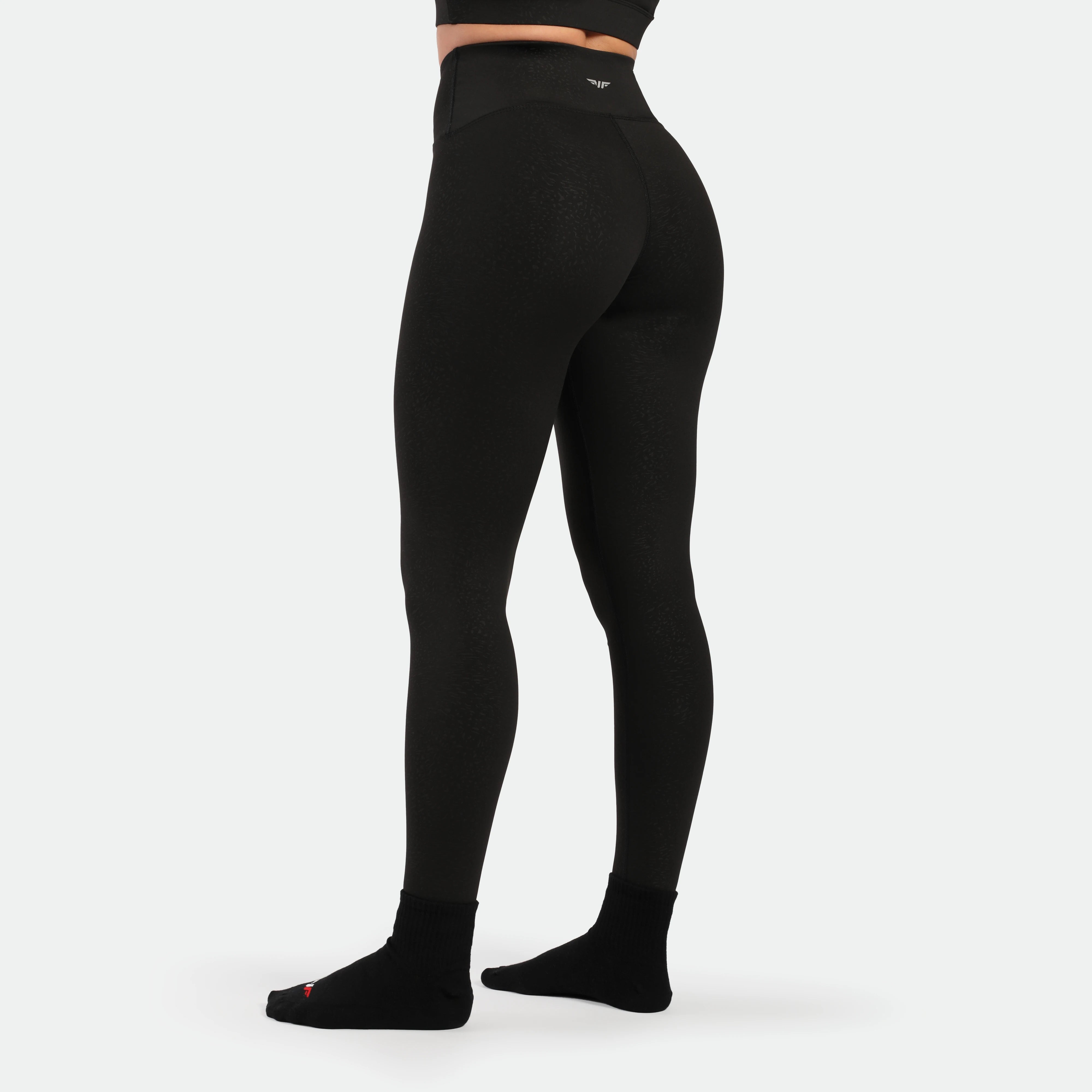 a back view for fit woman wearing legging black with socks black 