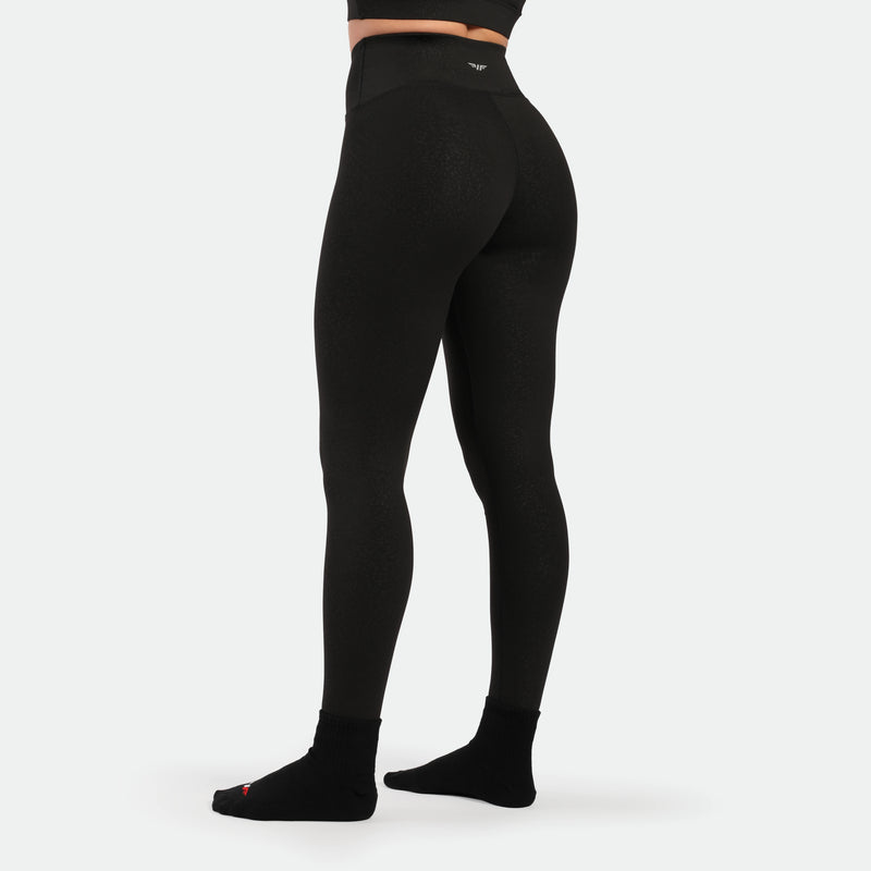 a back view for fit woman wearing legging black with socks black 