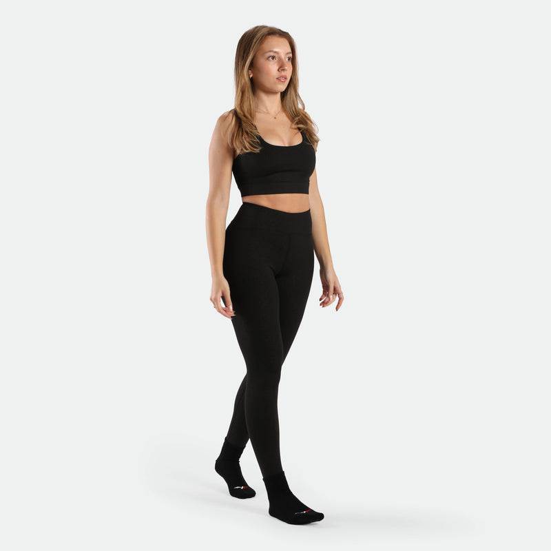 a fit woman wearing matching set black ,bra and legging ,plus the socks 