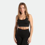 a fit woman wearing matching set black ,bra and legging 
