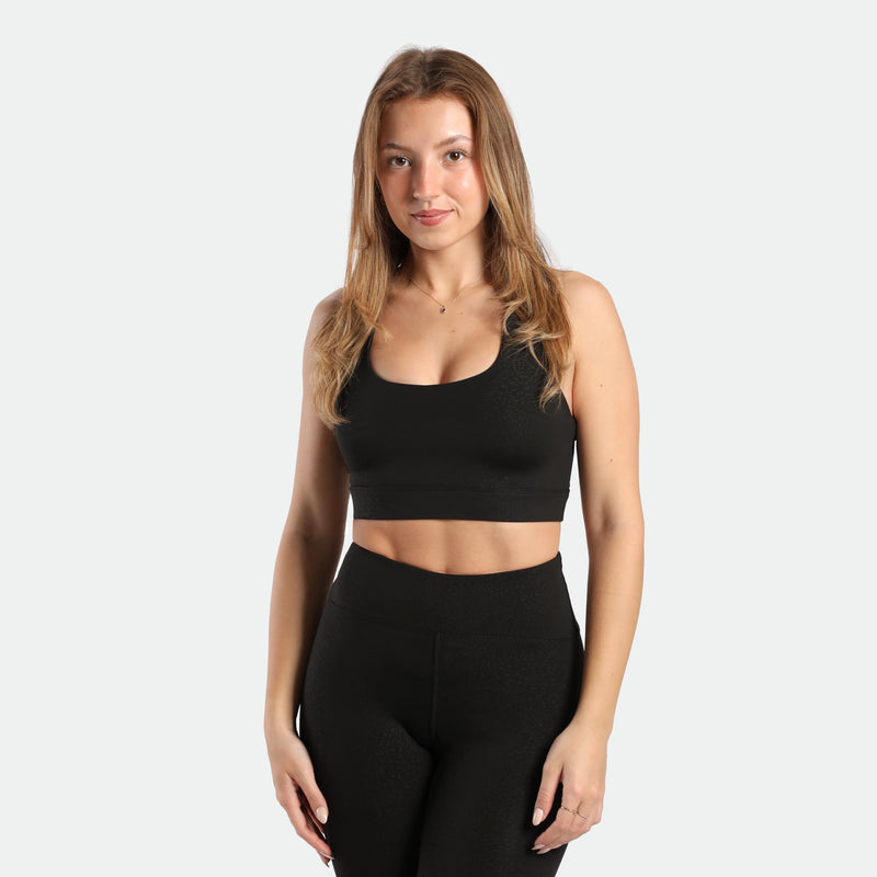a fit woman wearing matching set black ,bra and legging 