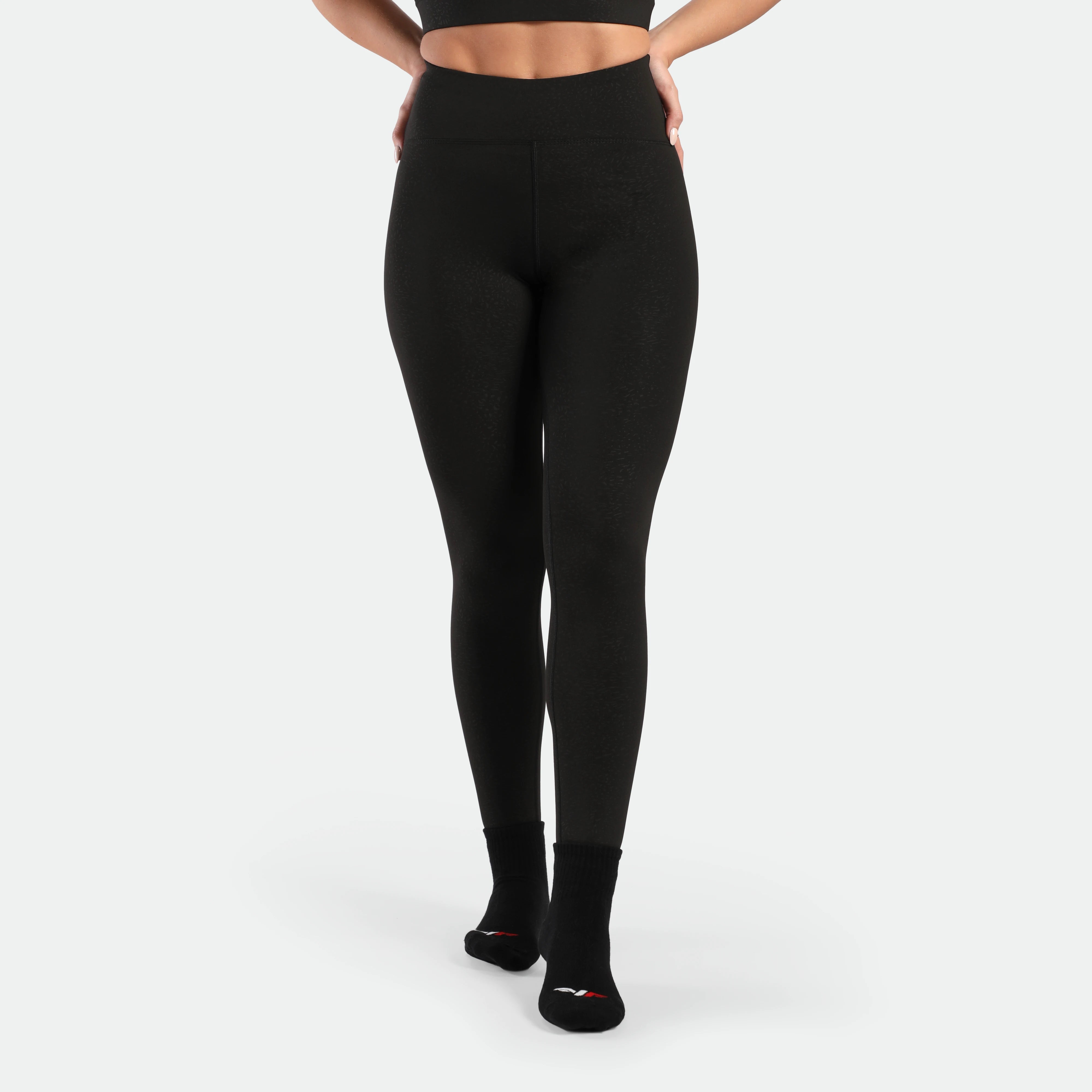 a fit woman wearing legging black with socks black 