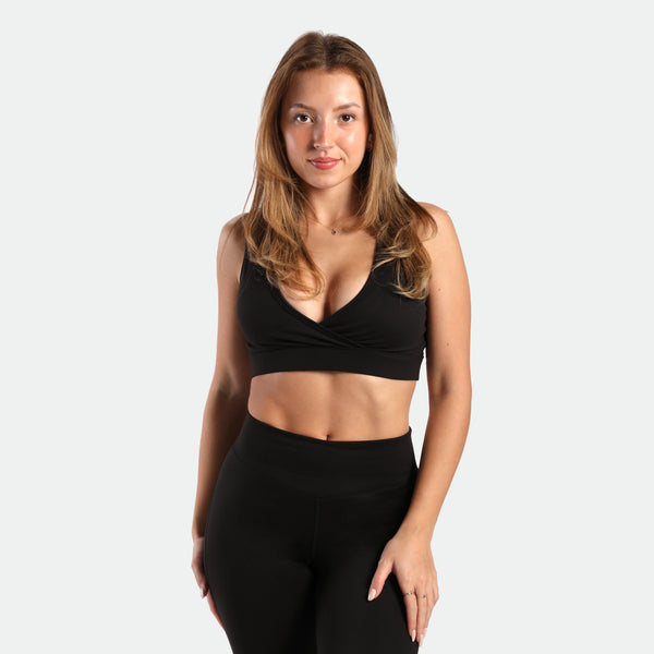 a fit woman wearing matching set black ,bra and flared legging 