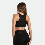 a back view for fit woman wearing matching set black ,bra and flared legging 