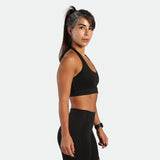 a fit woman stand at right and wearing matching set graphite  grey ,bra and short 