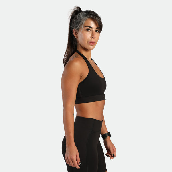 a fit woman stand at right and wearing matching set graphite  grey ,bra and short 
