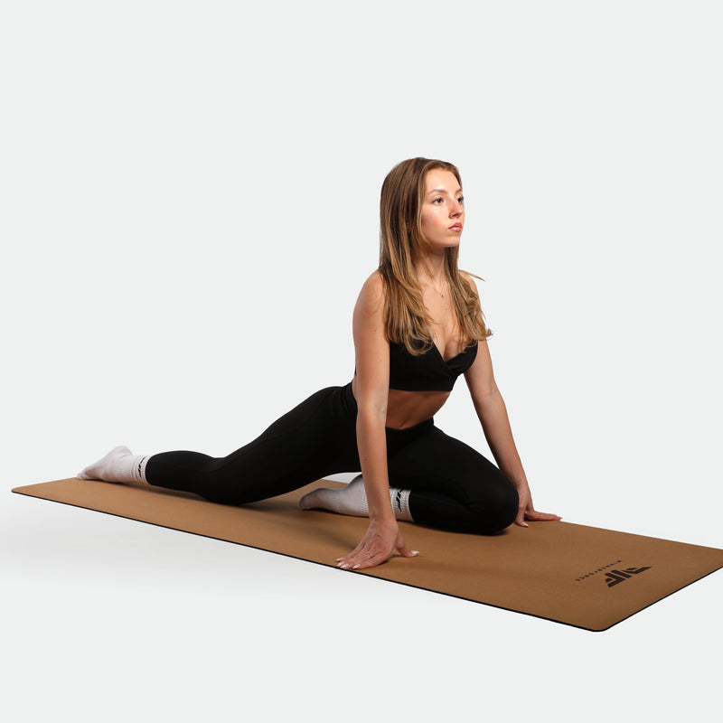 woman with exercise yoga ,she wearing matching set black ,bra and legging ,plus the socks white and meat brown  