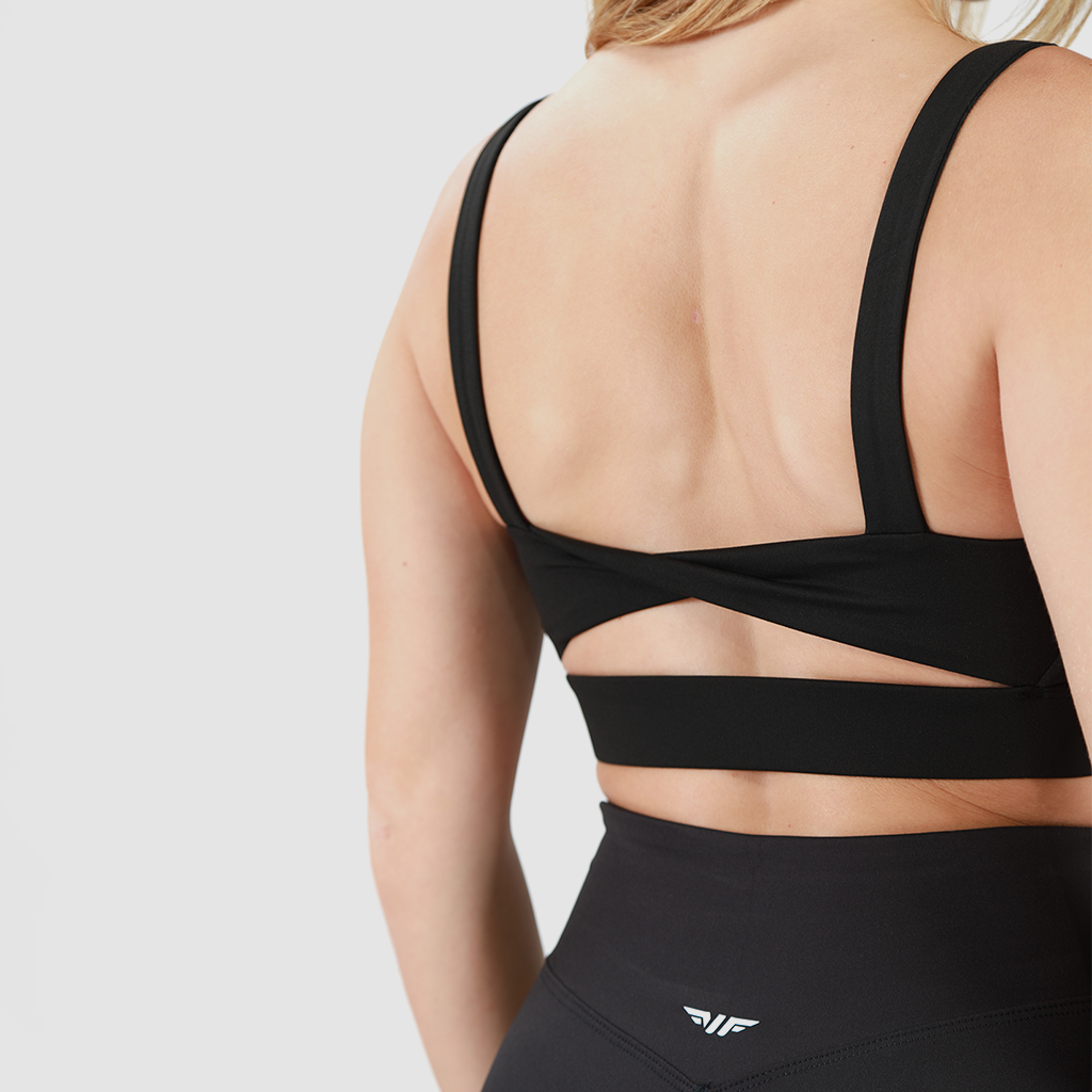  a back view for woman wearing bra with specials  design  and wearing a short it is same color  and add logo, plus the background is light grey