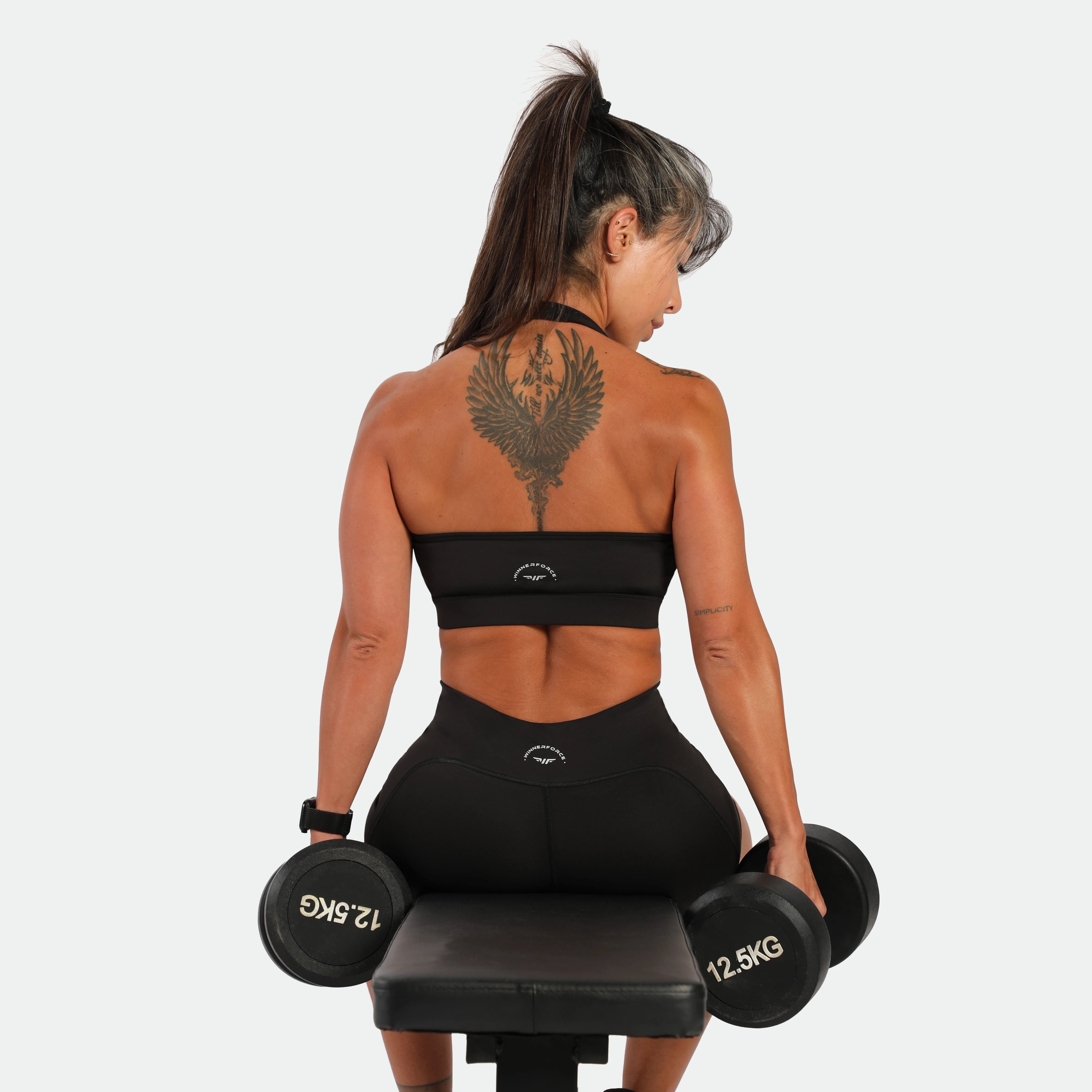 a back view or fit  woman wearing matching set black ,bra and legging 