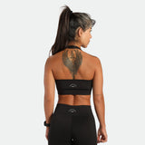 a back view for fit woman wearing matching set black ,bra an short ,plus the logo 
