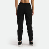 a back view for fit woman wearing black cargo pants with shoes ,plus the  background is light grey 