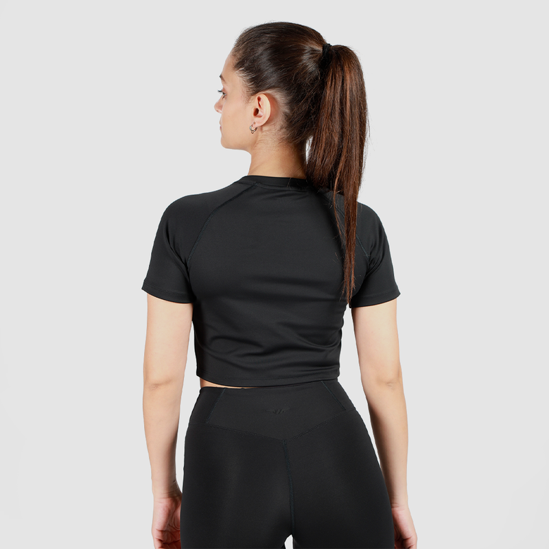 a back view for fit woman wearing crop top black with legging 