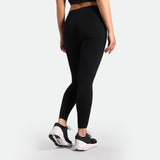 a back view for fit woman wearing legging black with shoes black 
