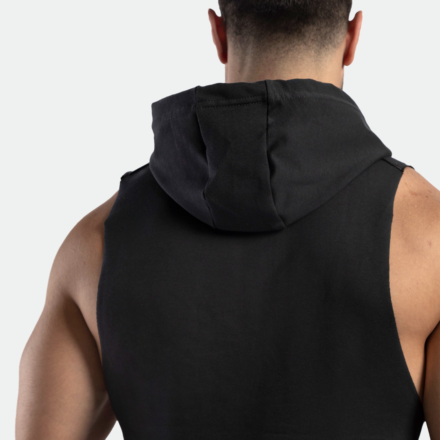 a back view for fit man wearing half hoodie shadow black 
