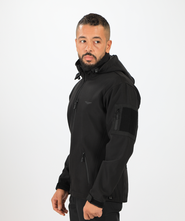 a fit man stand at right and wearing a polo jacket  black ,with pants black 