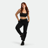 Woman wearing a black athletic outfit on a white background