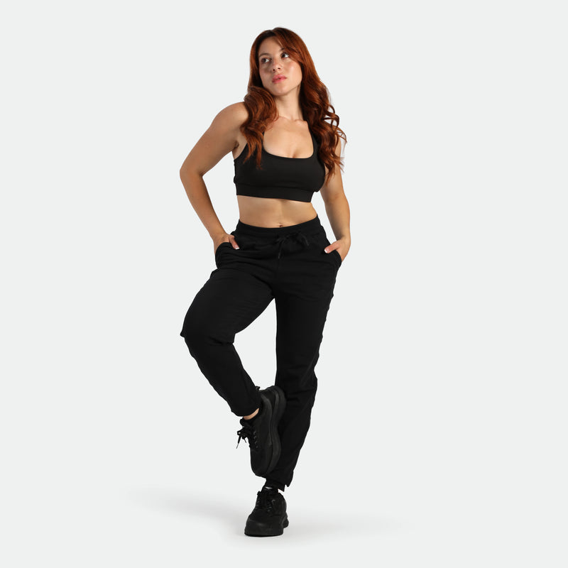 Woman wearing a black athletic outfit on a white background