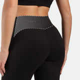 a back view for fit woman wearing legging  black with logo 