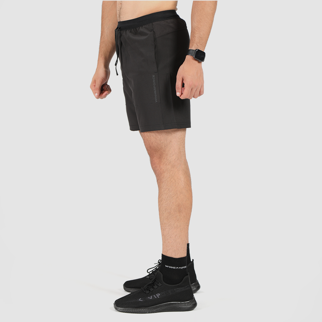 a fit man wearing short back with socks and shoes black 