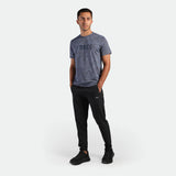 a fit man wearing t-shirt blue with pants black plus the shoes black 