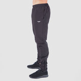 a fit man stand at right and wearing pants black with logo and shoes black 