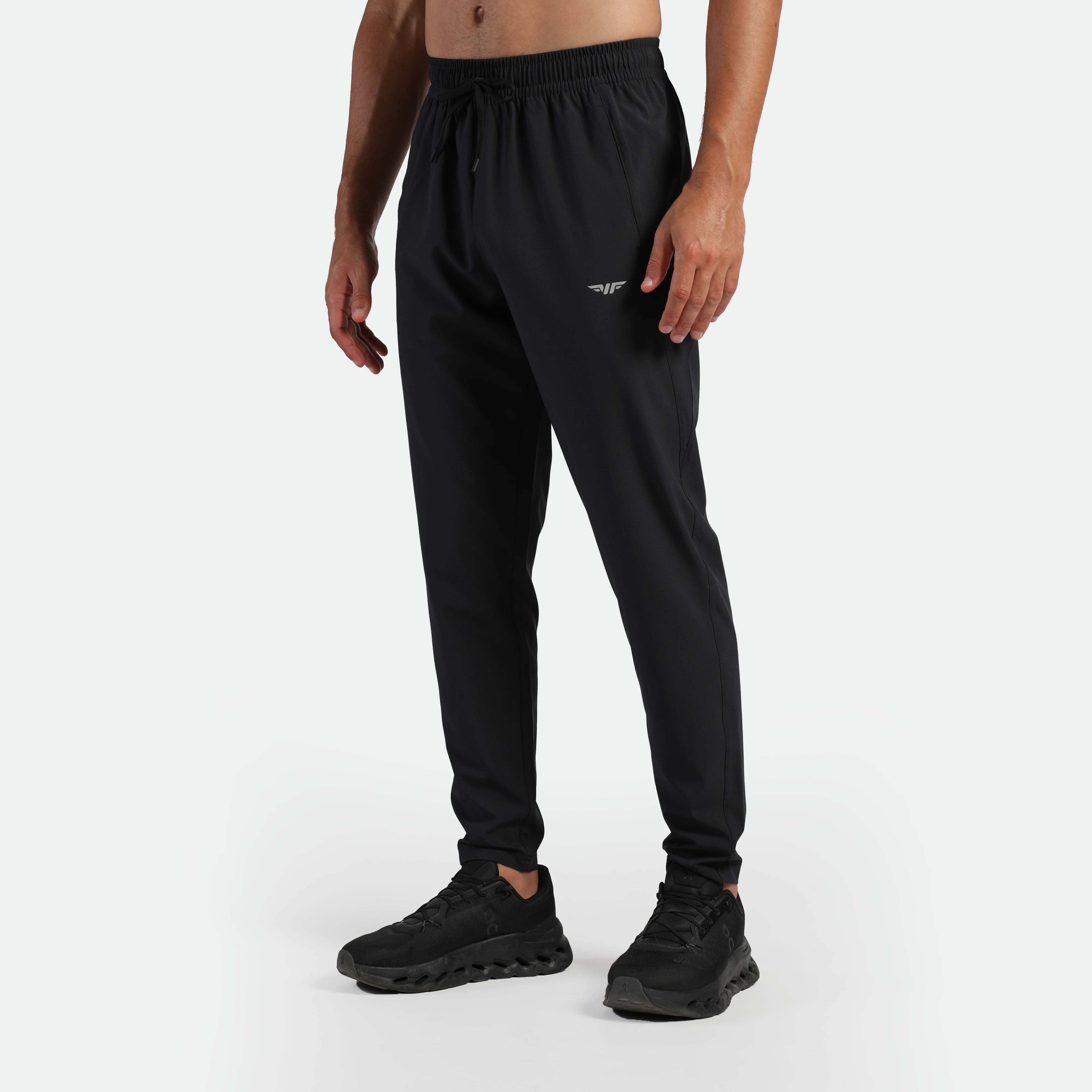 a fit man wearing pants black with shoes black 