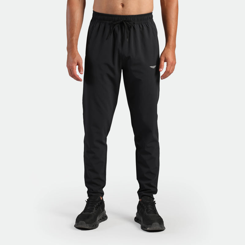 a fit man wearing pants black with shoes black 