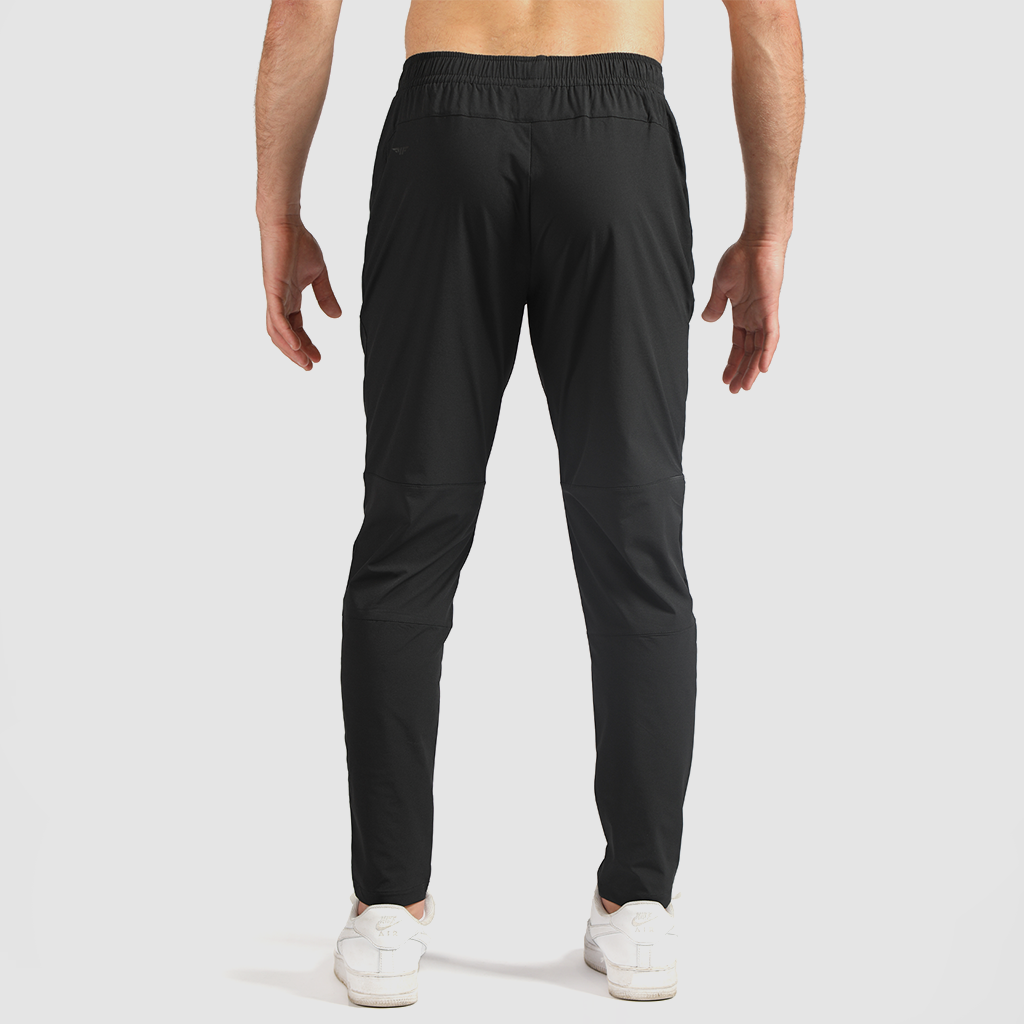 a back view for fit man wearing pants black with shoes 