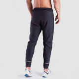 a back view for fit man wearing pants grey with shoes 