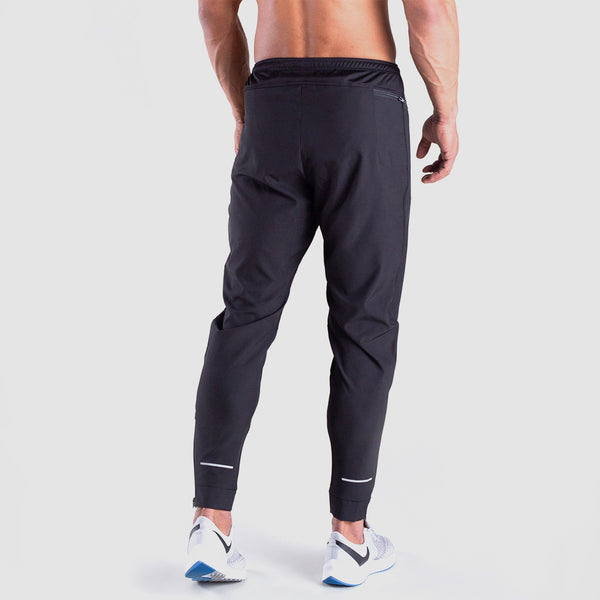 a back view for fit man wearing pants grey with shoes 