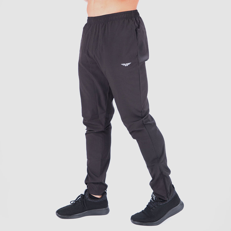 a fit man stand at right and wearing pants black with logo white and sneakers 
